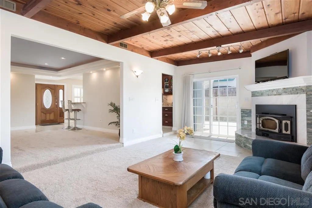 5168 Constitution Road San Diego, CA 92117 - Photo 9 of 25 a living room with fireplace furniture and a flat screen tv