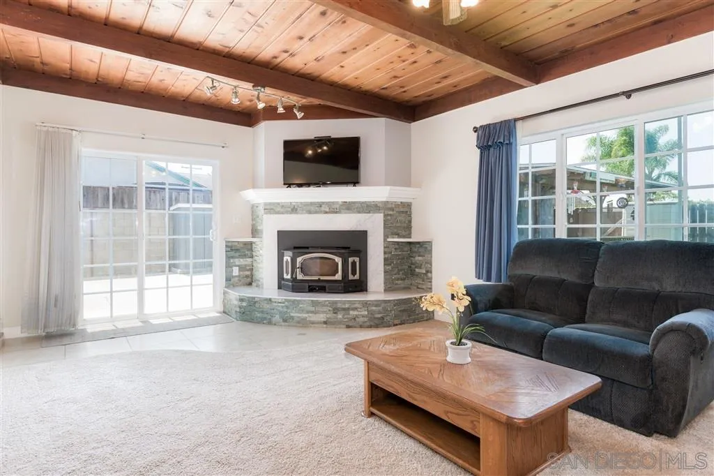 5168 Constitution Road San Diego, CA 92117 - Photo 10 of 25 a living room with furniture a flat screen tv and a fireplace