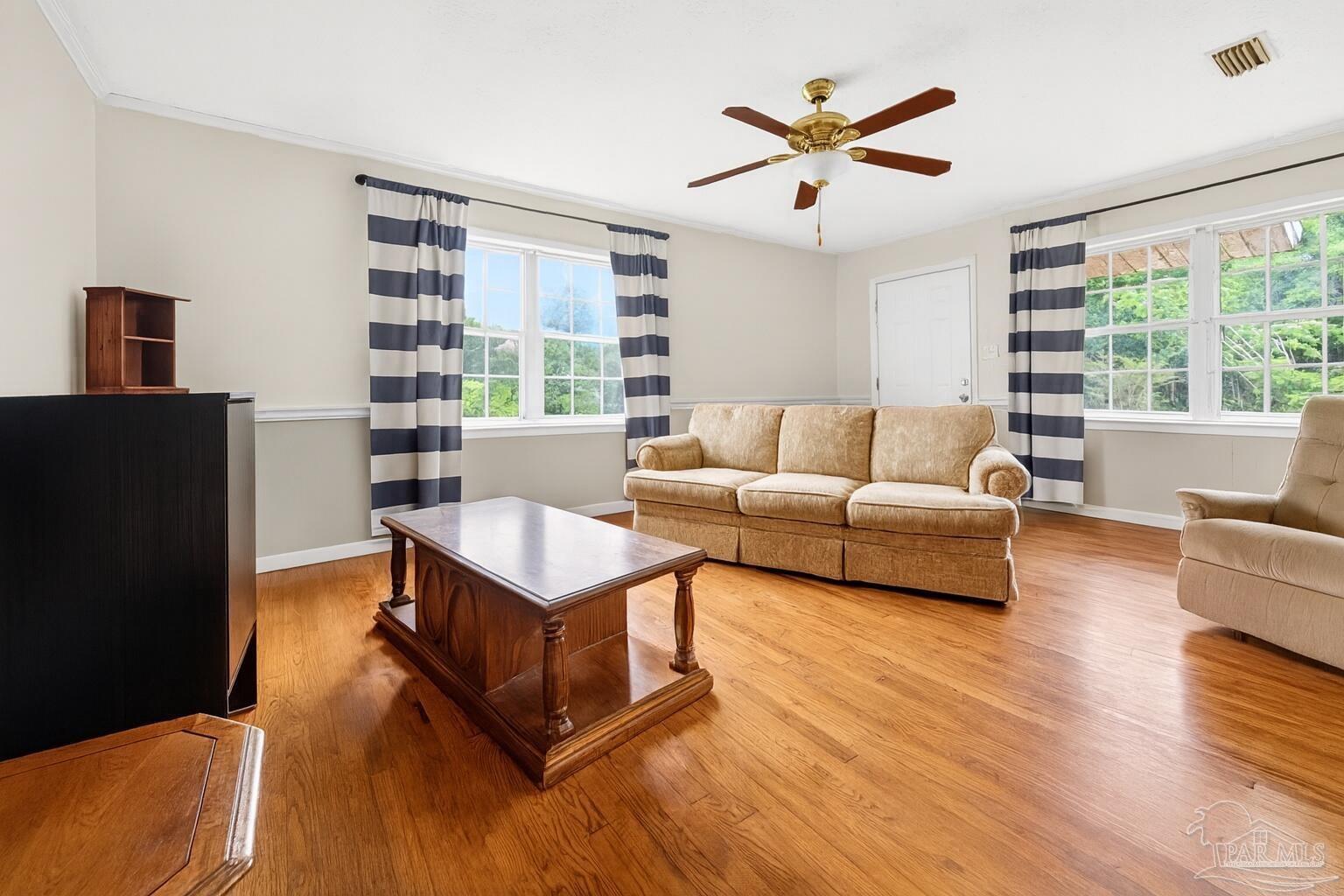 6253 Allentown Road Milton, FL 32570 - Photo 16 of 31 a living room with furniture and a large window with wooden floor