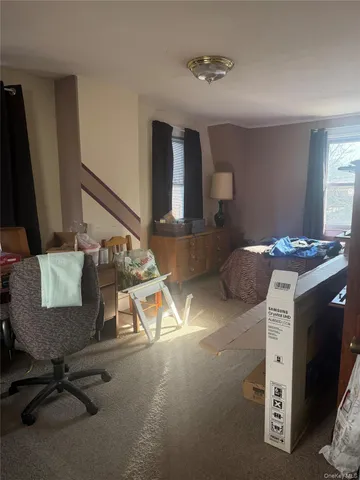 a bedroom with furniture and a window