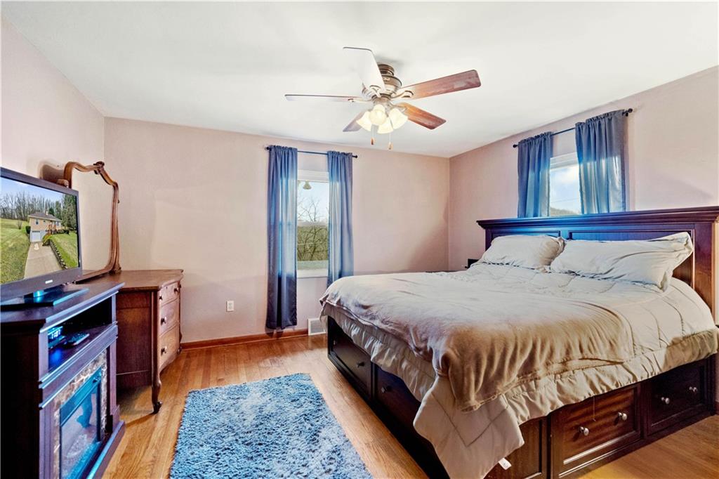 2861 Italy Road Export, PA 15632 - Photo 8 of 19 a bedroom with a bed and a flat screen tv