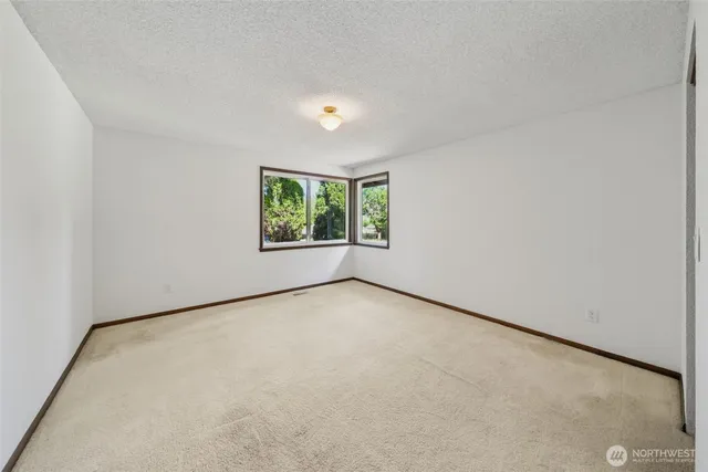 a bathroom with a sink double vanity granite and a window