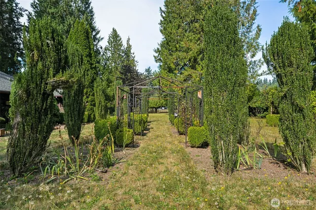 a view of a garden with a house in the background