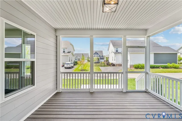 a view of a porch with wooden floor and fence