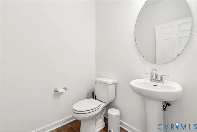 a bathroom with a sink toilet and a mirror
