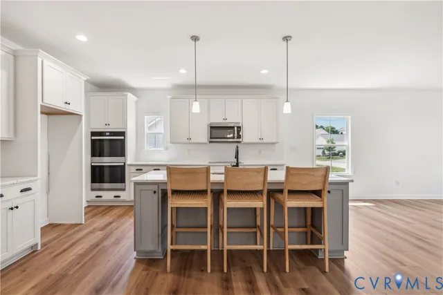 a large kitchen with a table and chairs