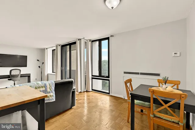a view of a dining room with furniture and a window