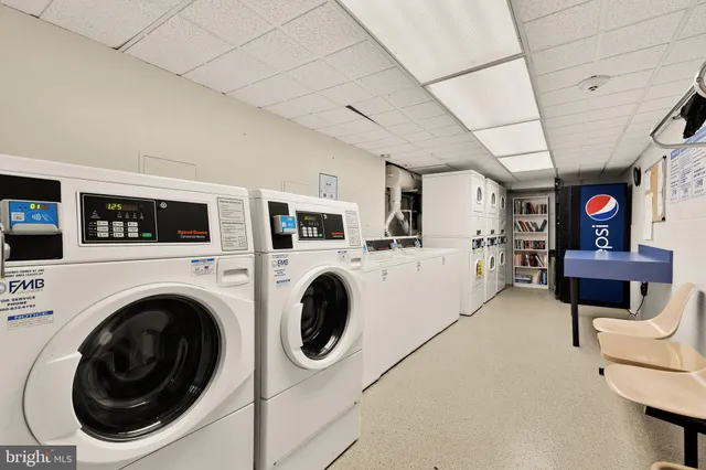 a living room with furniture a flat screen tv and a table