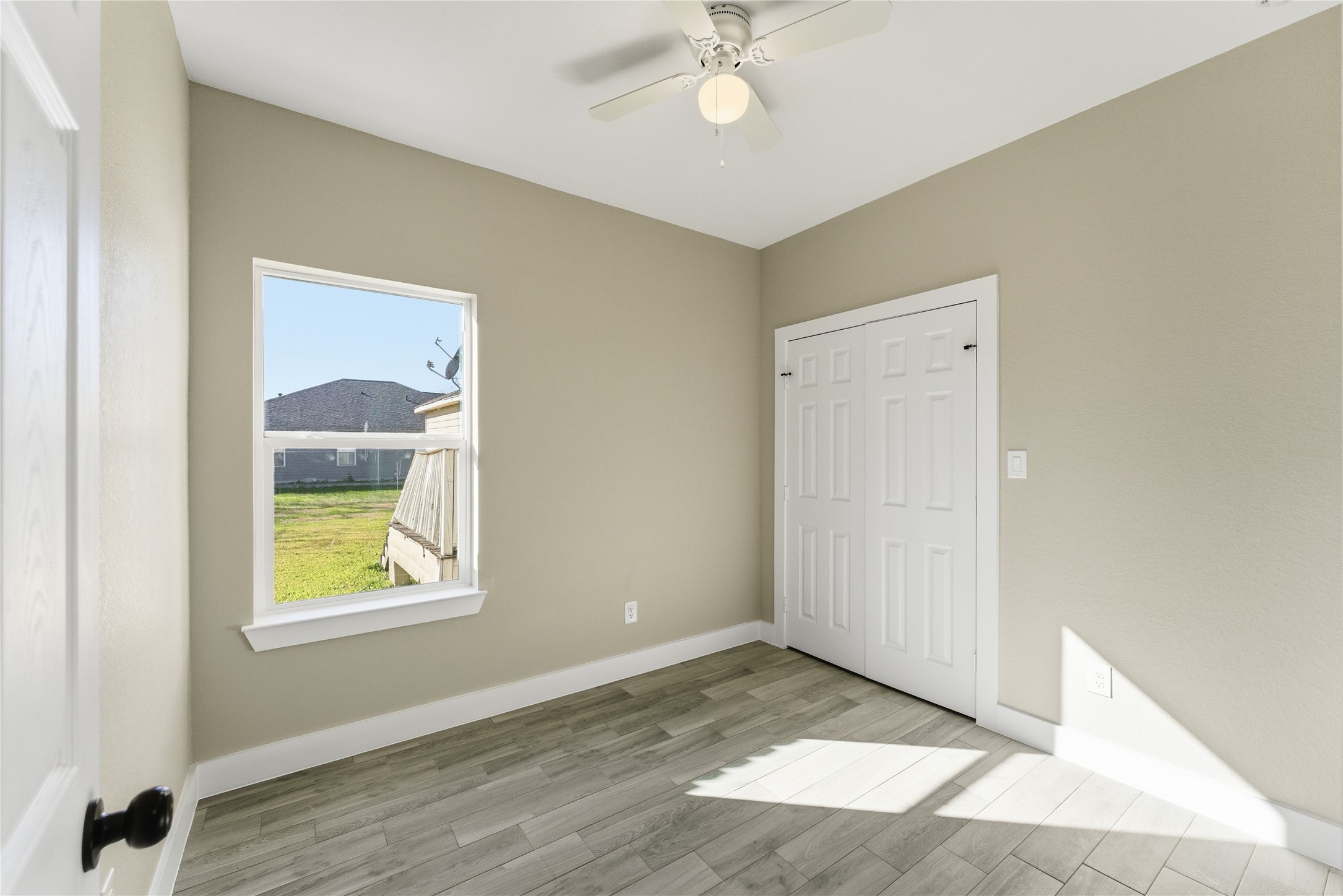 9722 Tuffly Street Houston, TX 77029 - Photo 11 of 16 a view of an empty room with wooden floor and a window