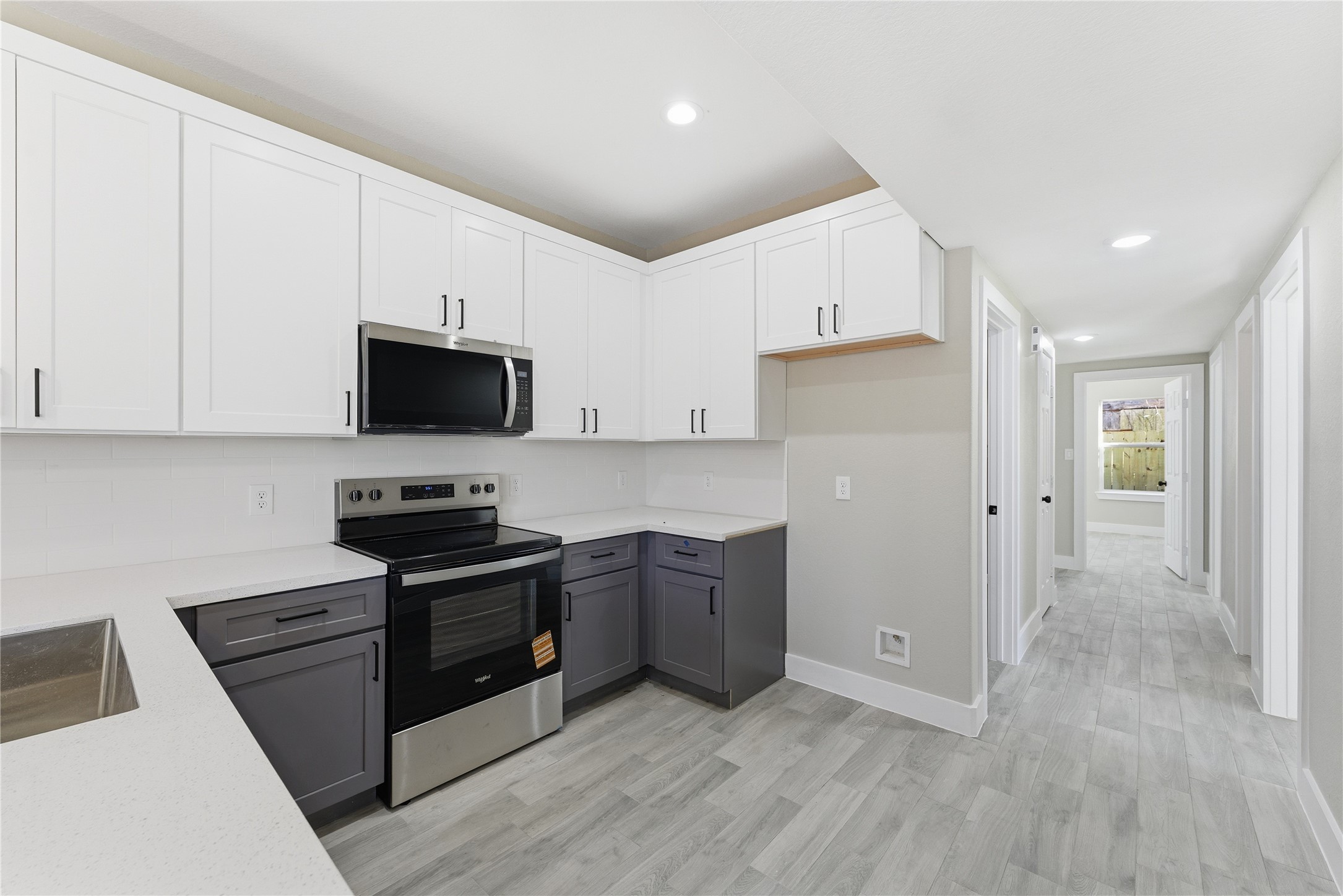 9722 Tuffly Street Houston, TX 77029 - Photo 15 of 16 a kitchen with a sink a stove and refrigerator