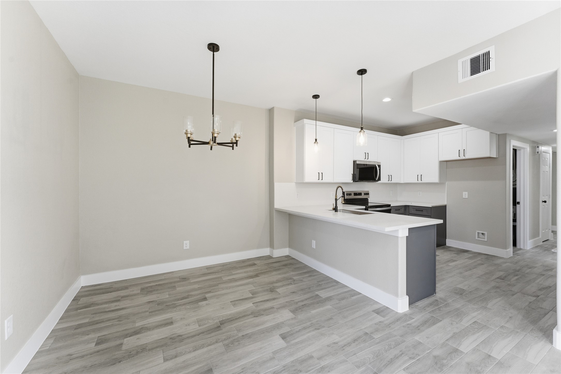 9722 Tuffly Street Houston, TX 77029 - Photo 16 of 16 a kitchen with stainless steel appliances granite countertop a sink a stove a refrigerator and white cabinets