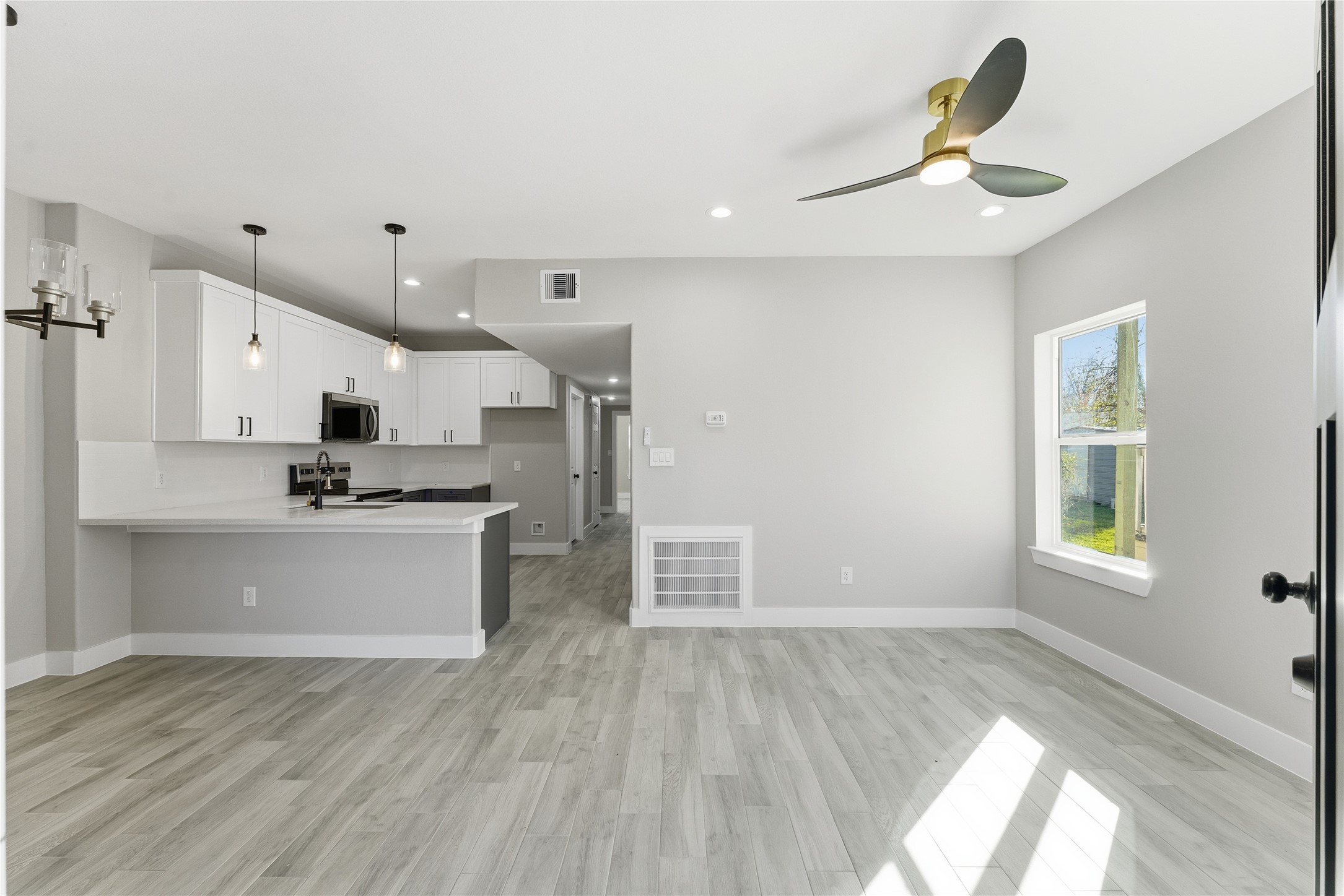 9722 Tuffly Street Houston, TX 77029 - Photo 3 of 16 a view of kitchen with wooden floor and window