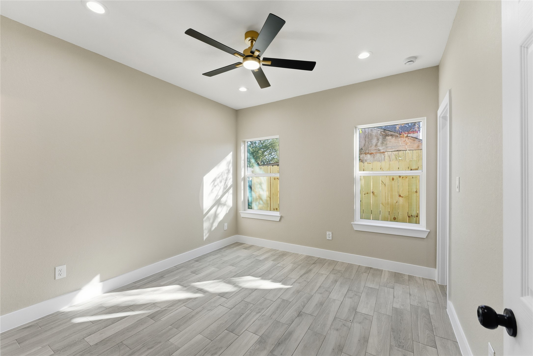 9722 Tuffly Street Houston, TX 77029 - Photo 8 of 16 a view of empty room with wooden floor and fan