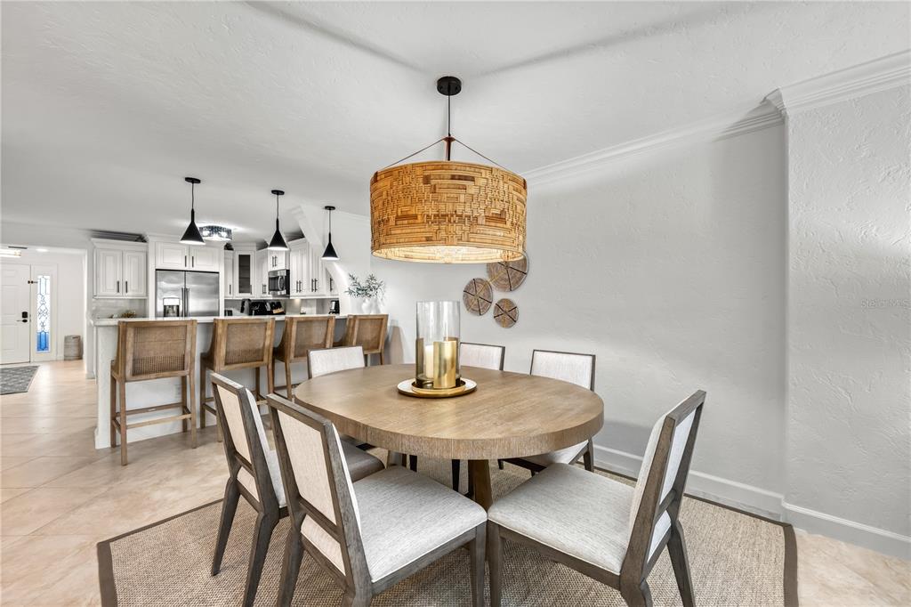 5880 Midnight Pass Road, Unit 210 Sarasota, FL 34242 - Photo 13 of 75 a view of a dining room with furniture window and wooden floor