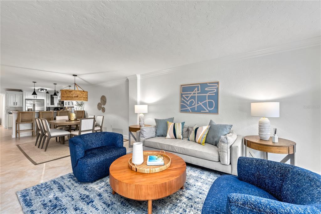 5880 Midnight Pass Road, Unit 210 Sarasota, FL 34242 - Photo 18 of 75 a living room with furniture a rug and a lamp