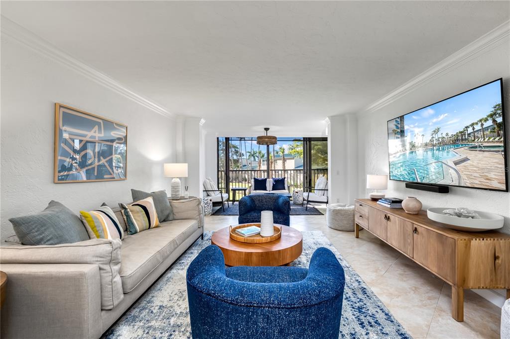 5880 Midnight Pass Road, Unit 210 Sarasota, FL 34242 - Photo 20 of 75 a living room with furniture and a flat screen tv