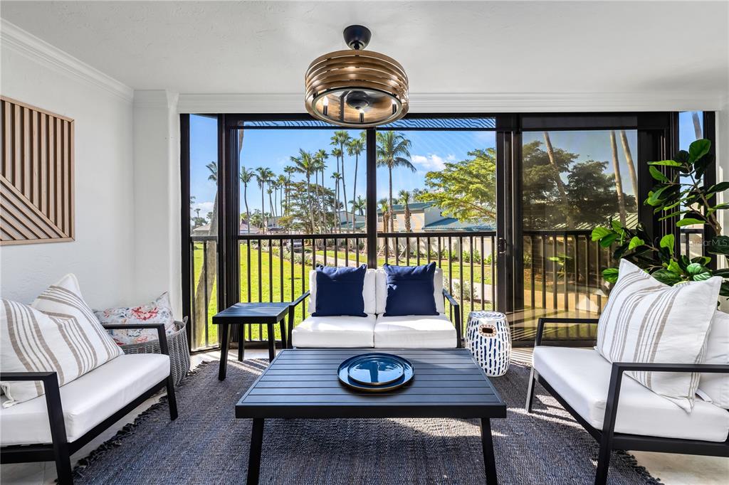 5880 Midnight Pass Road, Unit 210 Sarasota, FL 34242 - Photo 22 of 75 a living room with furniture and a large window