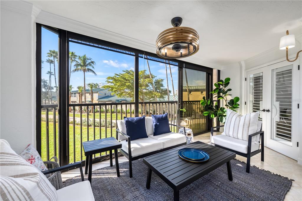 5880 Midnight Pass Road, Unit 210 Sarasota, FL 34242 - Photo 23 of 75 a living room with furniture and a window