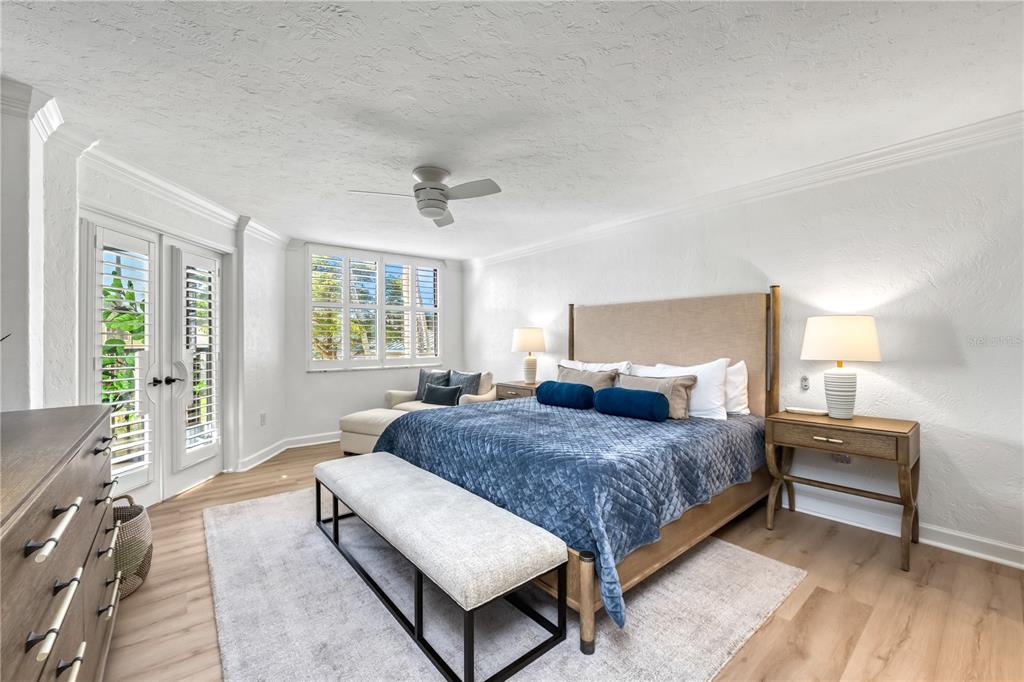 5880 Midnight Pass Road, Unit 210 Sarasota, FL 34242 - Photo 25 of 75 a bedroom with a bed and wooden floor