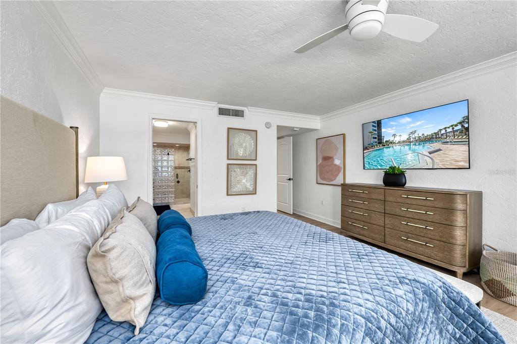 5880 Midnight Pass Road, Unit 210 Sarasota, FL 34242 - Photo 26 of 75 a bedroom with a bed and a dresser