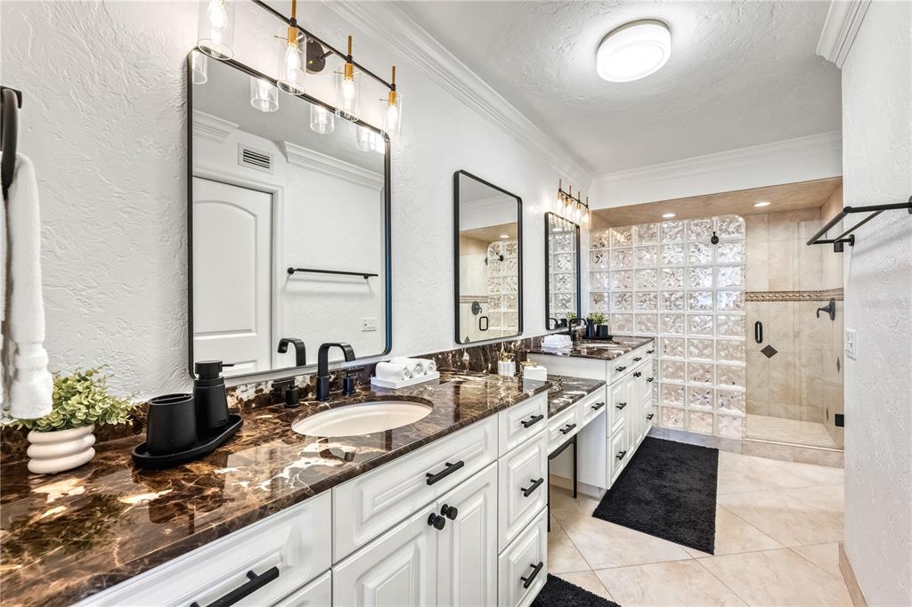 5880 Midnight Pass Road, Unit 210 Sarasota, FL 34242 - Photo 28 of 75 a bathroom with a granite countertop sink mirror and double