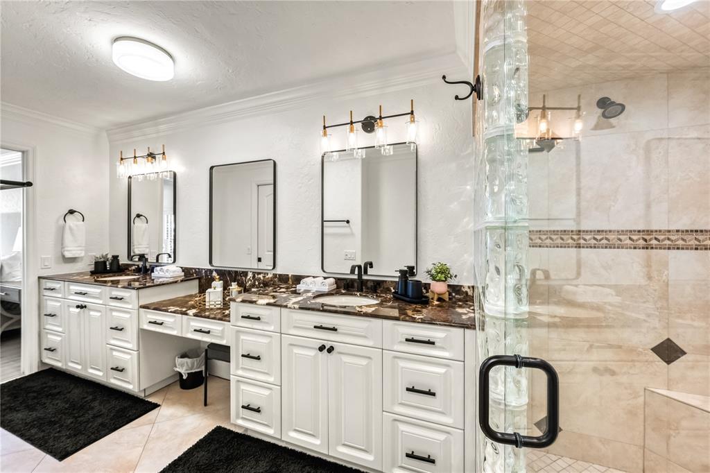 5880 Midnight Pass Road, Unit 210 Sarasota, FL 34242 - Photo 29 of 75 a bathroom with a double vanity sink a mirror and a shower