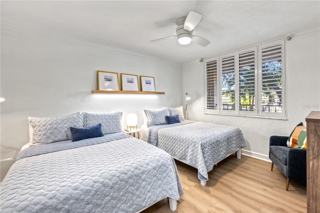 5880 Midnight Pass Road, Unit 210 Sarasota, FL 34242 - Photo 33 of 75 a bedroom with two beds and a large window