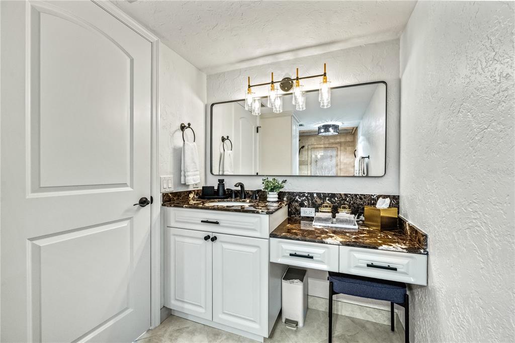 5880 Midnight Pass Road, Unit 210 Sarasota, FL 34242 - Photo 34 of 75 a bathroom with a sink and a mirror