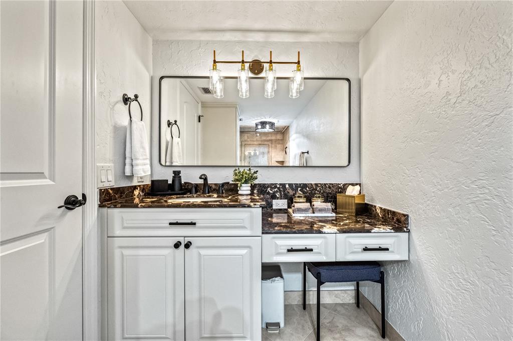 5880 Midnight Pass Road, Unit 210 Sarasota, FL 34242 - Photo 35 of 75 a bathroom with a sink and a mirror