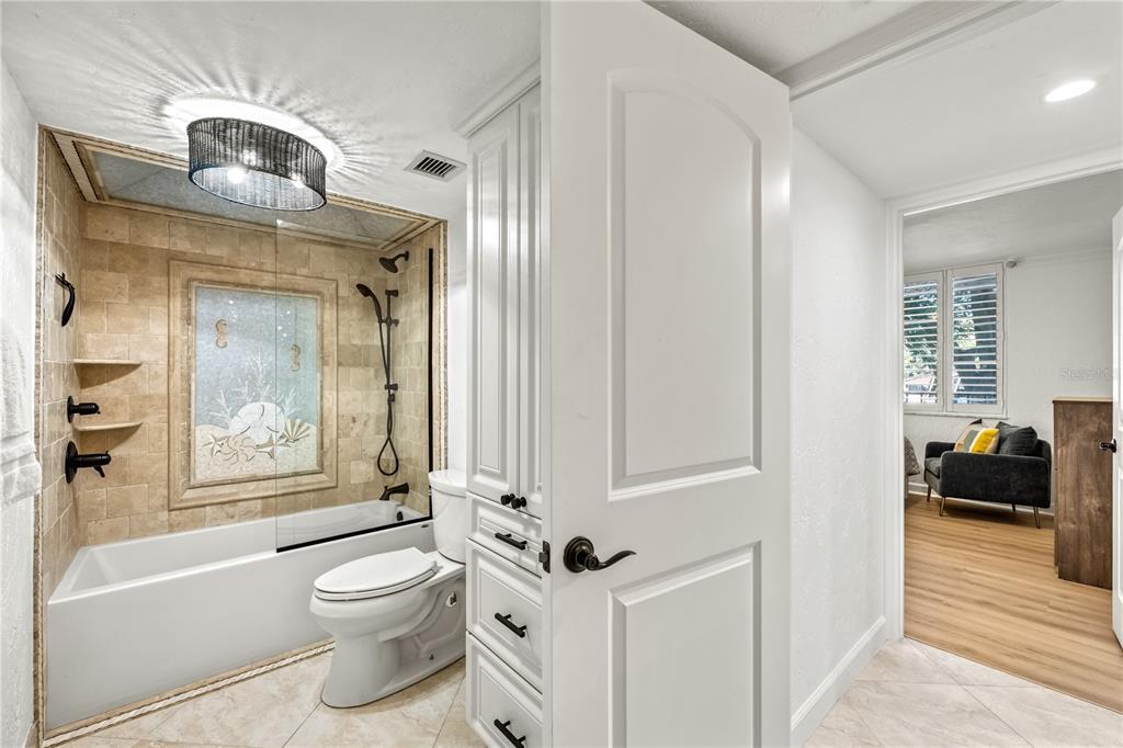 5880 Midnight Pass Road, Unit 210 Sarasota, FL 34242 - Photo 36 of 75 a bathroom with a toilet a sink and a bathtub