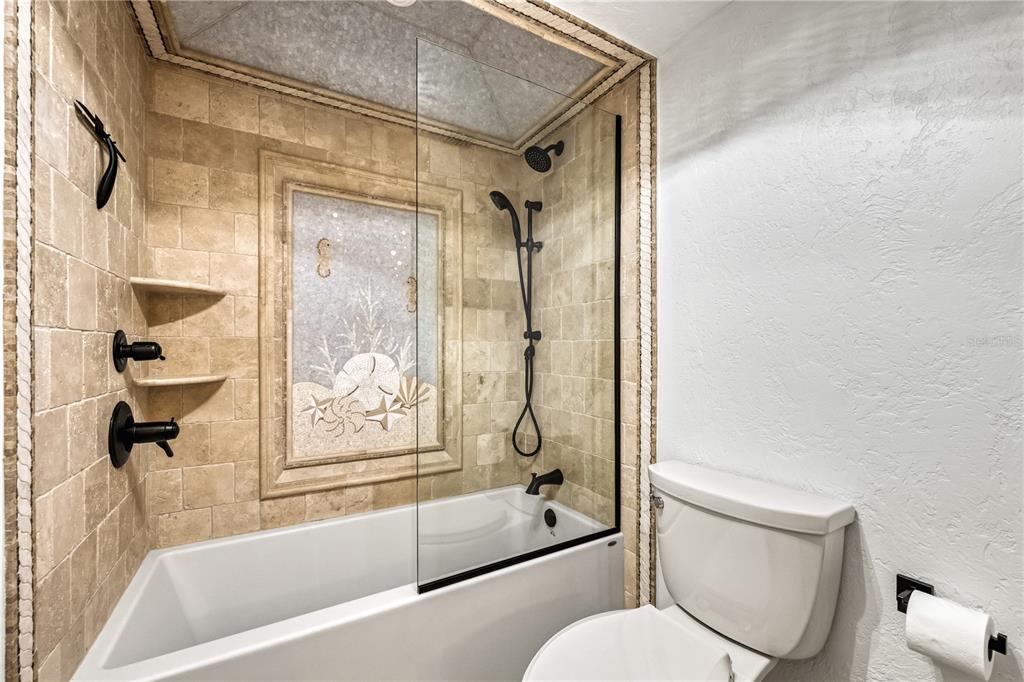 5880 Midnight Pass Road, Unit 210 Sarasota, FL 34242 - Photo 37 of 75 a bathroom with a toilet and a bathtub