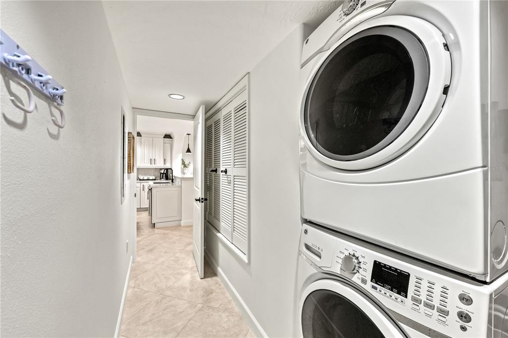 5880 Midnight Pass Road, Unit 210 Sarasota, FL 34242 - Photo 41 of 75 a view of a hallway with washer and dryer