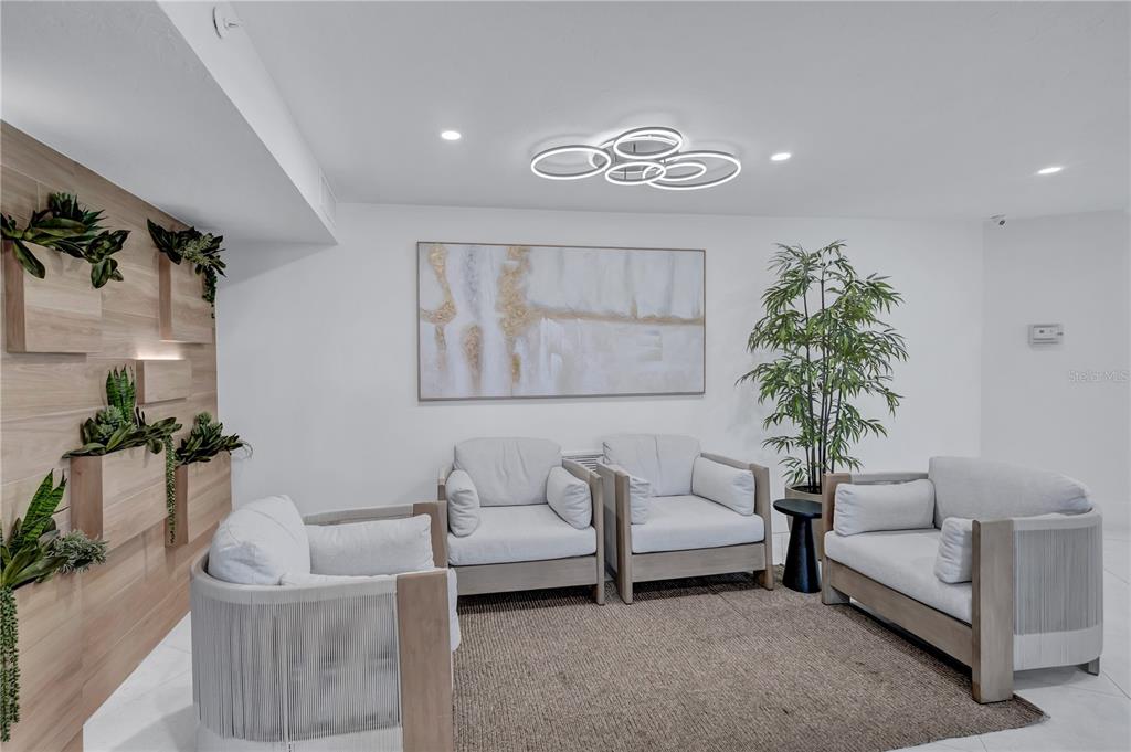 5880 Midnight Pass Road, Unit 210 Sarasota, FL 34242 - Photo 47 of 75 a living room with furniture and a chandelier