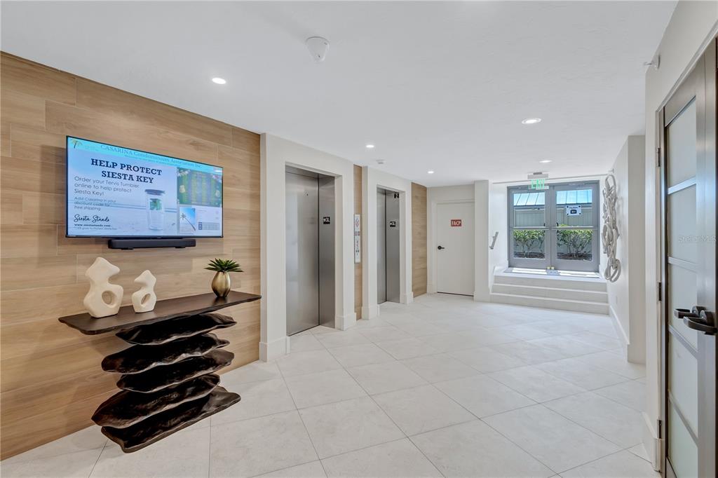 5880 Midnight Pass Road, Unit 210 Sarasota, FL 34242 - Photo 48 of 75 a room with furniture and wooden floor