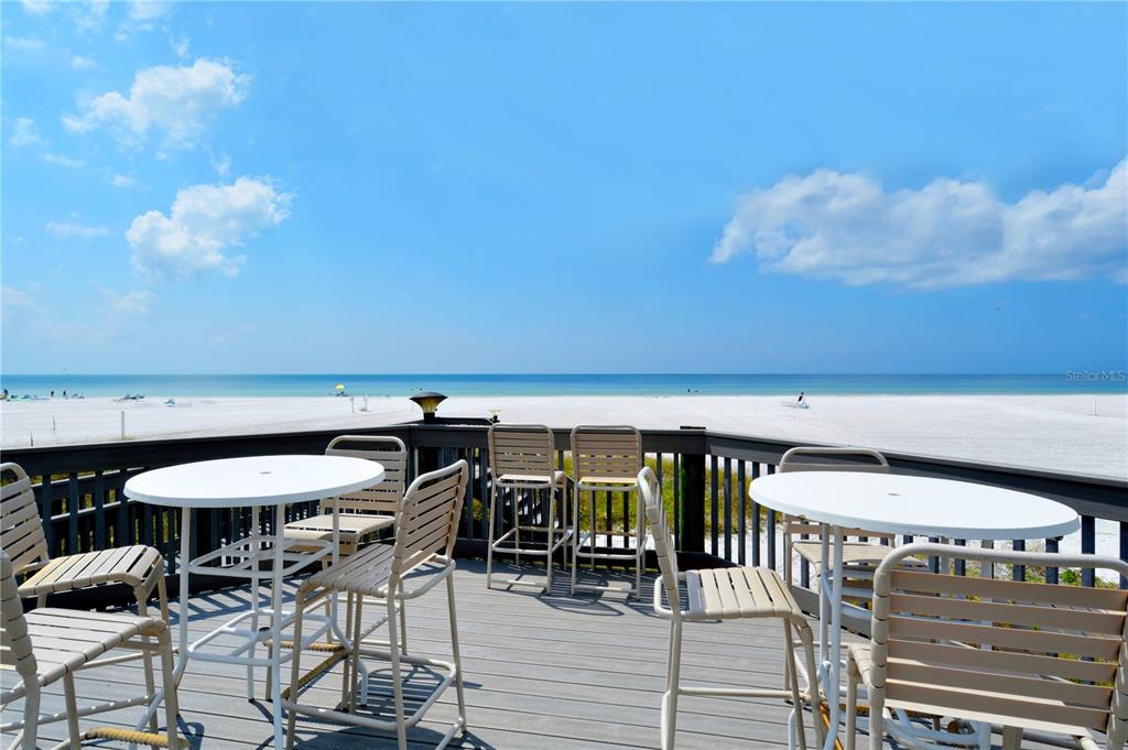 5880 Midnight Pass Road, Unit 210 Sarasota, FL 34242 - Photo 56 of 75 a view of a chairs and table in patio