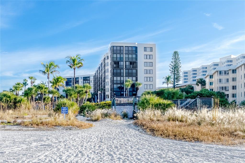 5880 Midnight Pass Road, Unit 210 Sarasota, FL 34242 - Photo 60 of 75 a front view of a house with garden