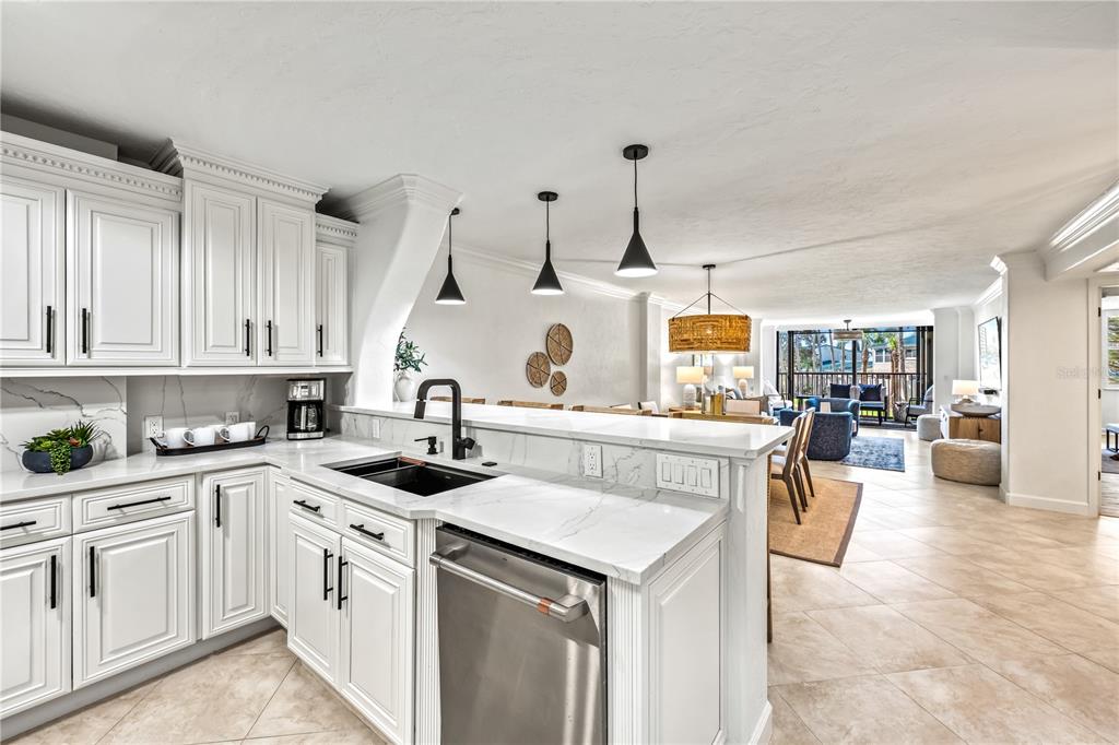5880 Midnight Pass Road, Unit 210 Sarasota, FL 34242 - Photo 6 of 75 a kitchen with a sink stove and cabinets