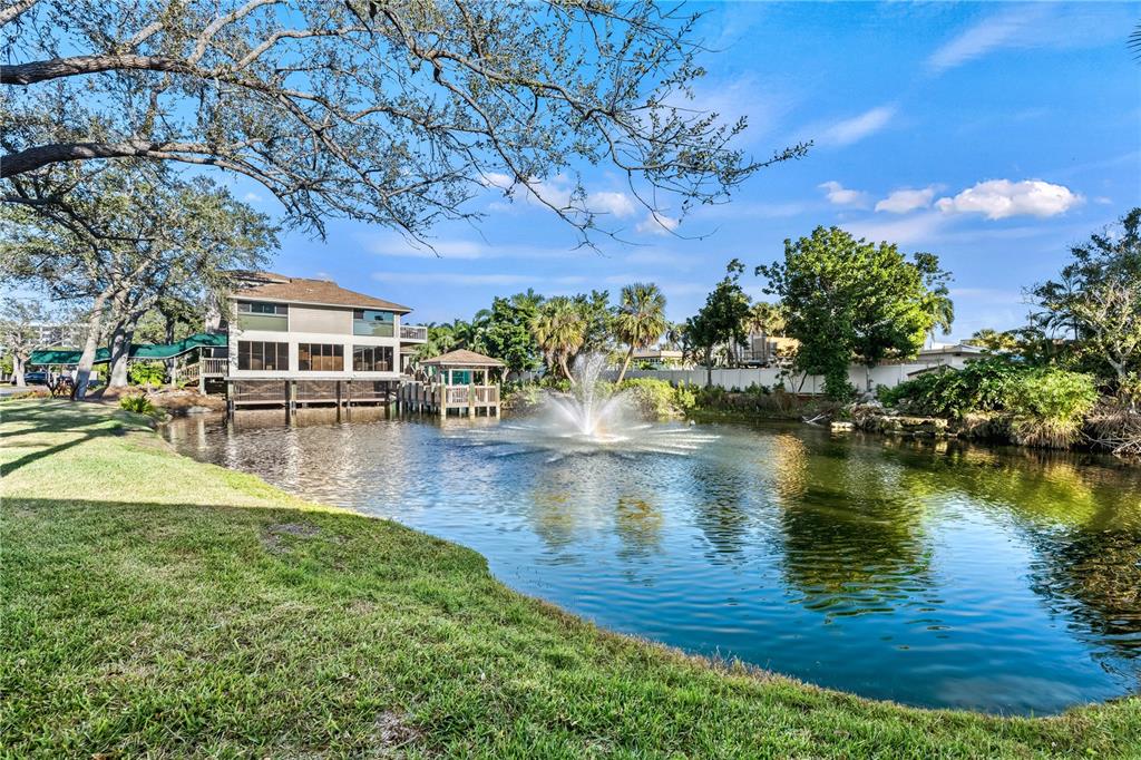 5880 Midnight Pass Road, Unit 210 Sarasota, FL 34242 - Photo 62 of 75 a swimming pool with outdoor seating and yard