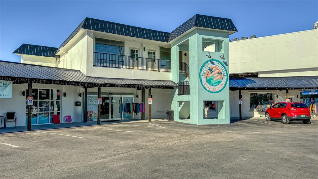 5880 Midnight Pass Road, Unit 210 Sarasota, FL 34242 - Photo 64 of 75 a front view of a building with retail shop and retail shops