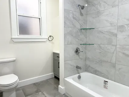 a bathroom with a toilet and a bathtub
