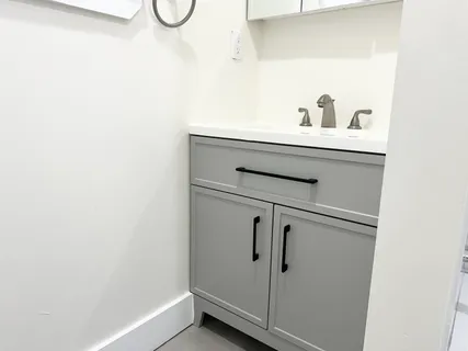 a bathroom with a sink and a mirror