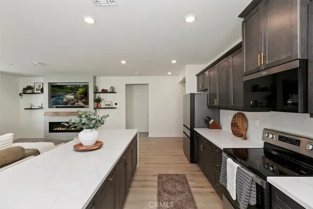 a kitchen with stainless steel appliances kitchen island granite countertop a sink and stove top oven