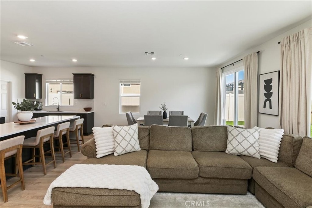 29224 Outback Lane Winchester, CA 92596 - Photo 17 of 35 a living room with furniture and a dining table with wooden floor