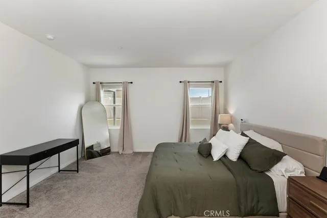 a bedroom with a bed and a mirror