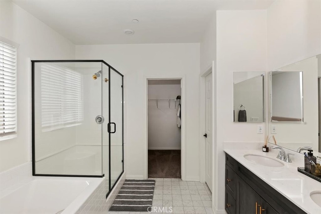29224 Outback Lane Winchester, CA 92596 - Photo 22 of 35 a bathroom with a double vanity sink a mirror and a shower