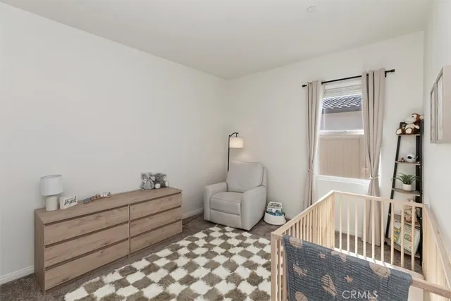 a bedroom with furniture and wooden floor