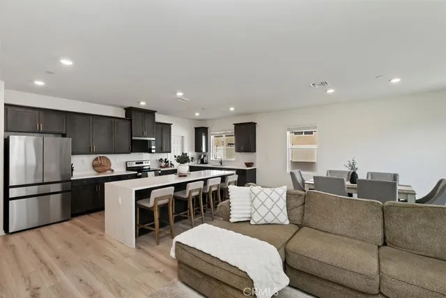 a living room with furniture and kitchen view