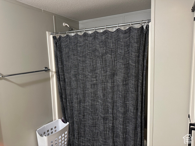 1375 West 500th North, Unit 95 Provo, UT 84601 - Photo 8 of 19 Bathroom featuring a textured ceiling and a shower with curtain