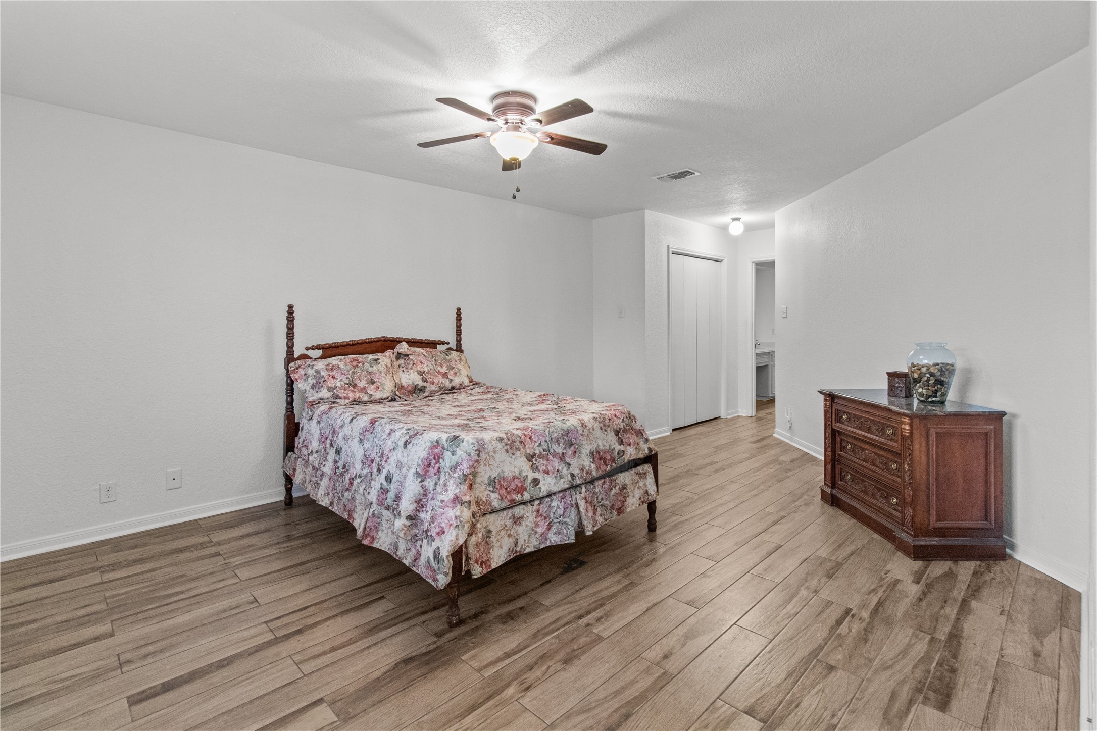 9 Colony Square Angleton, TX 77515 - Photo 17 of 23 a bedroom with a bed and wooden floor