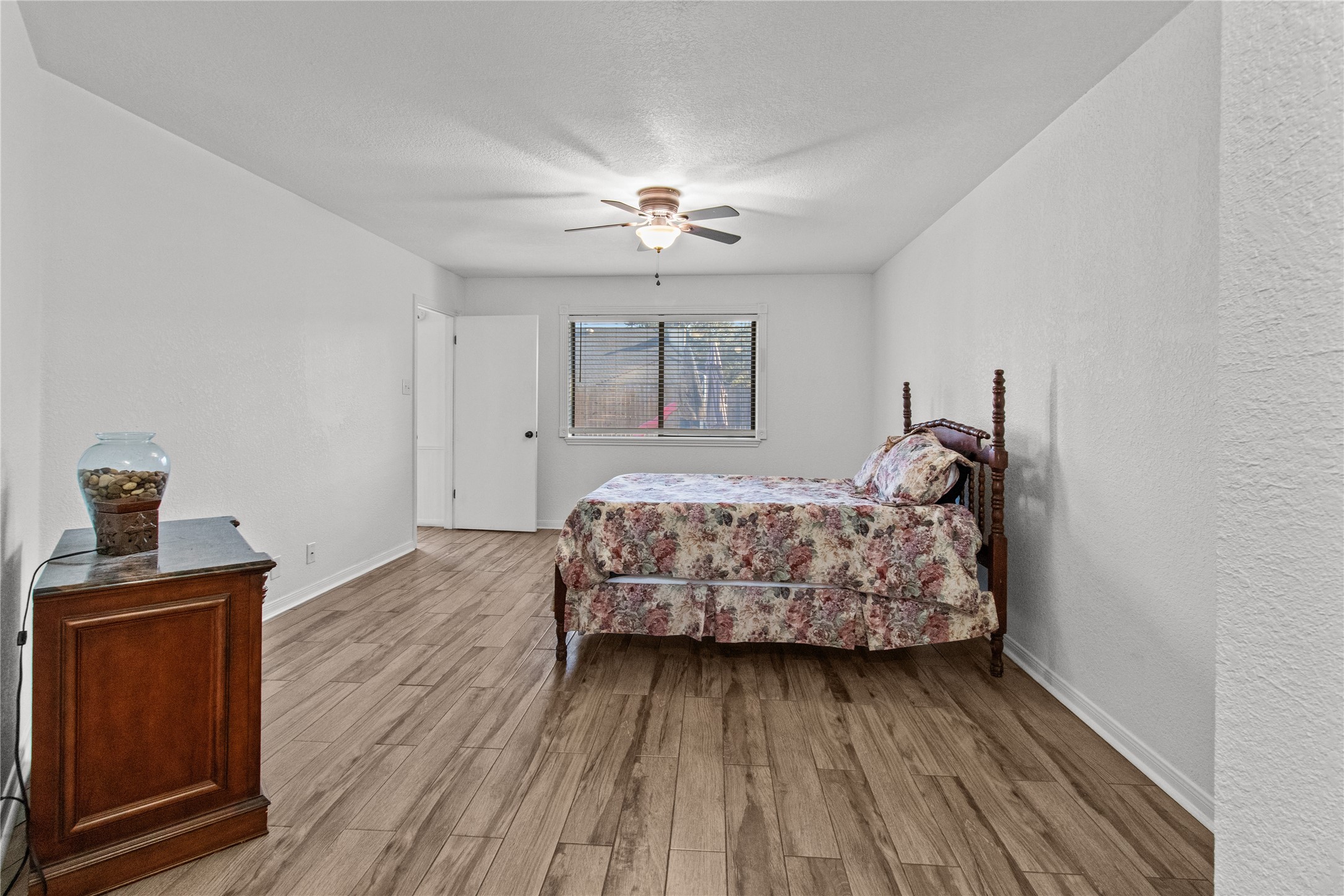 9 Colony Square Angleton, TX 77515 - Photo 18 of 23 a bedroom with bed and wooden floor